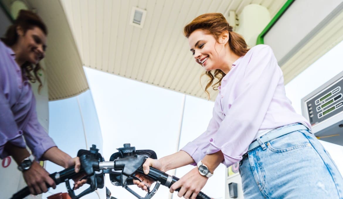 Woman pumping fuel at petrol station