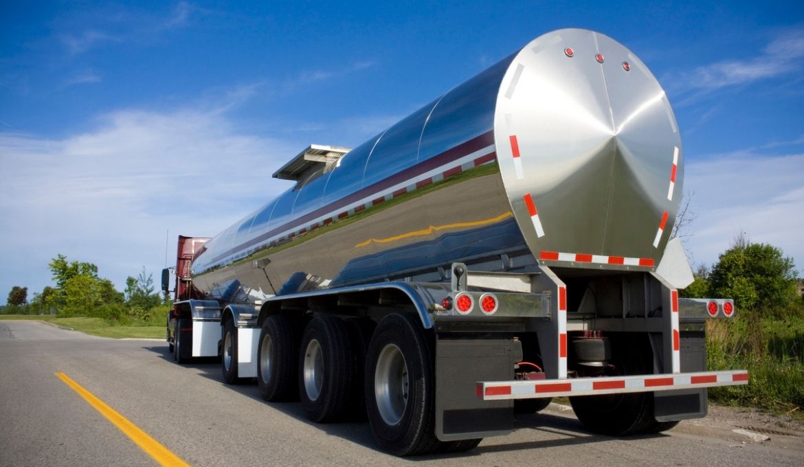 fuel truck driving down a road